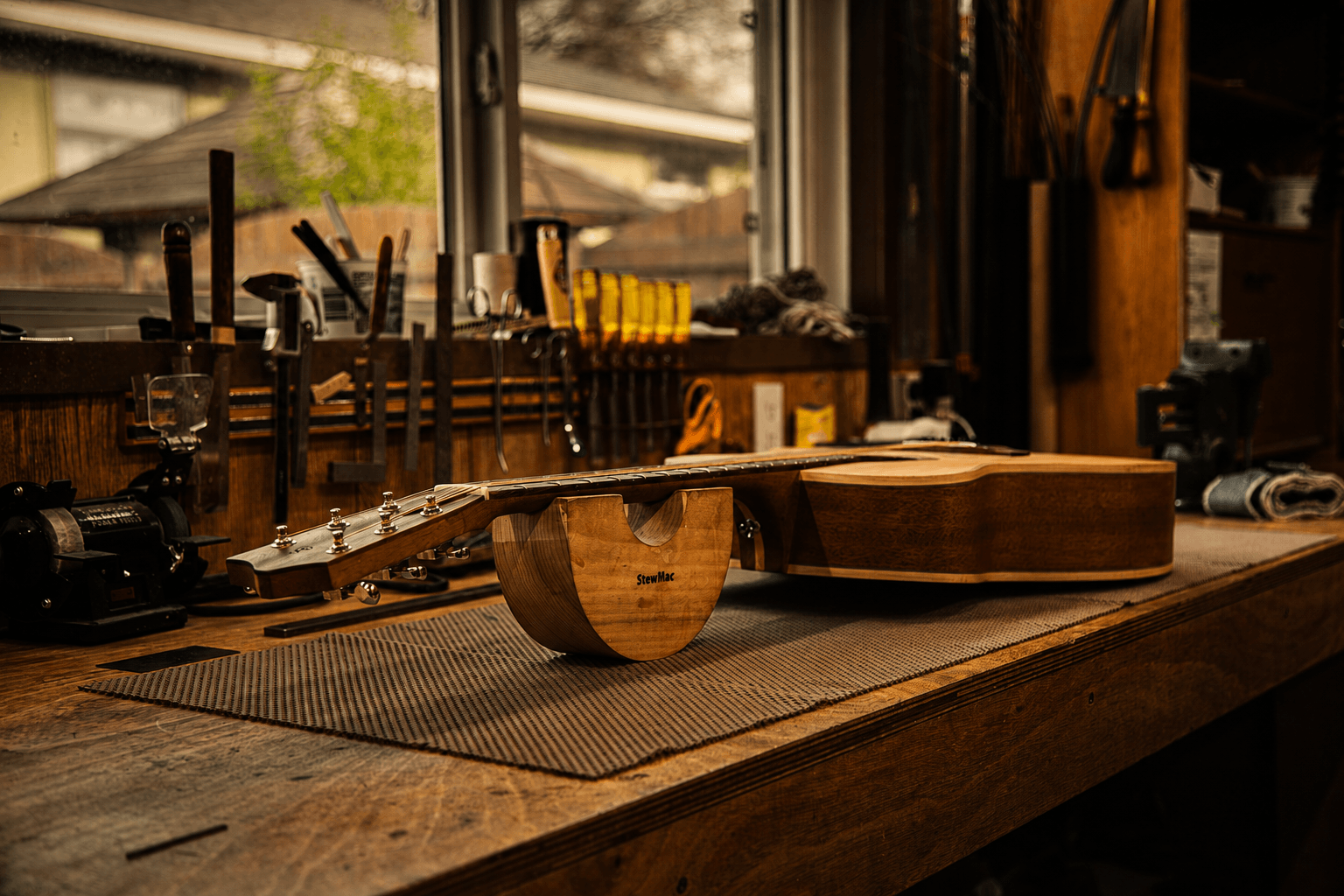 Detailed woodworking tools on a clean luthier workbench
